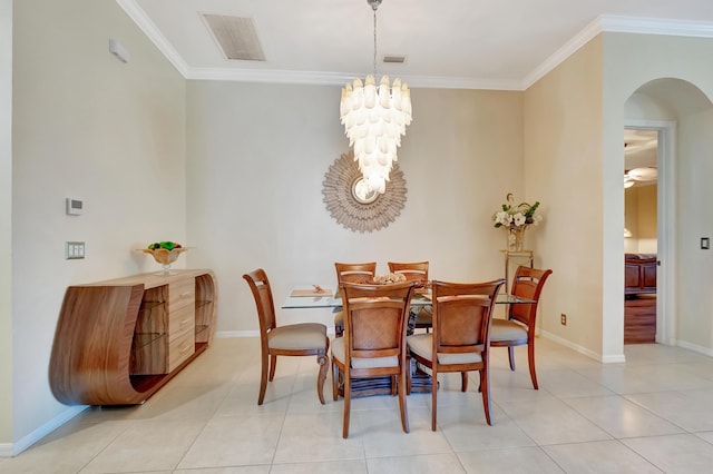 dining space with a notable chandelier, light tile patterned floors, and crown molding