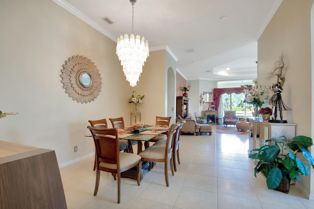 tiled dining space with a chandelier and crown molding