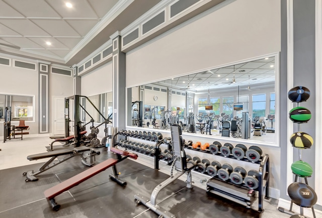 gym with ceiling fan and ornamental molding