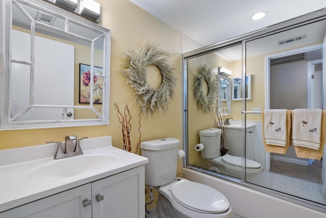 full bathroom with vanity, enclosed tub / shower combo, and toilet