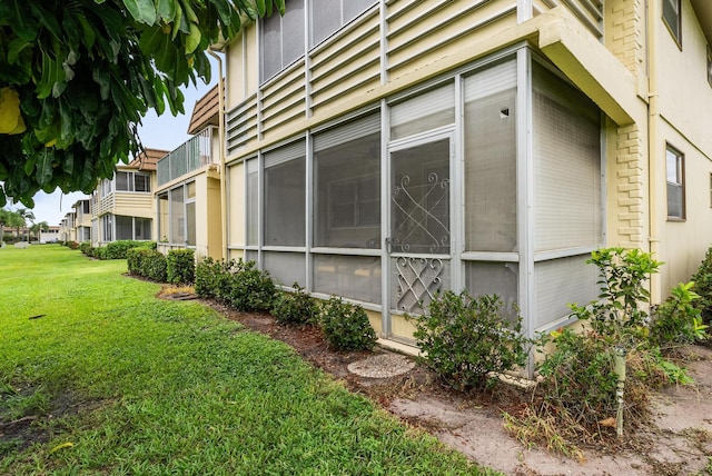 view of side of property with a lawn