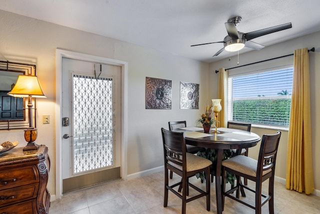 tiled dining room featuring ceiling fan