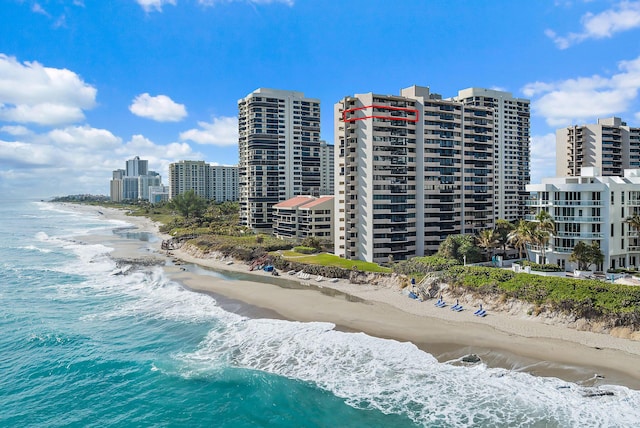 exterior space featuring a water view and a beach view