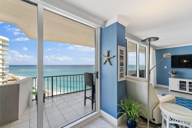 balcony featuring a beach view and a water view