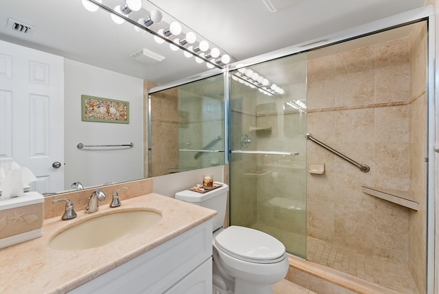 bathroom with an enclosed shower, vanity, and toilet