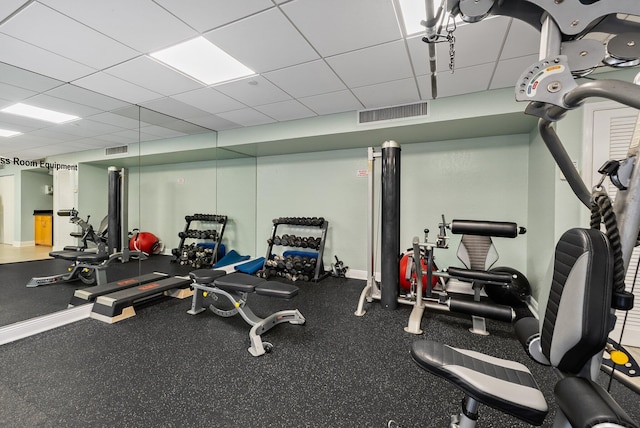 workout area with a paneled ceiling