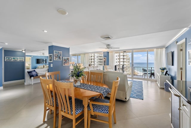 dining space featuring ceiling fan, expansive windows, a healthy amount of sunlight, and ornamental molding