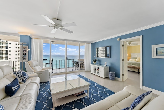 living room featuring floor to ceiling windows, crown molding, and a water view