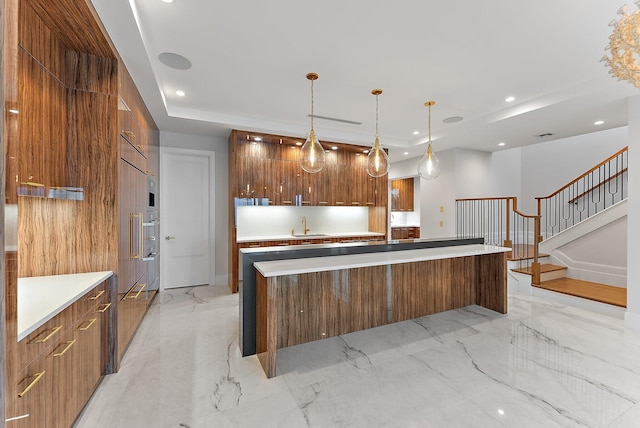 kitchen with a spacious island, sink, and pendant lighting