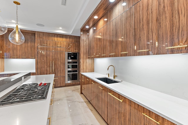 kitchen featuring pendant lighting, stainless steel appliances, and sink