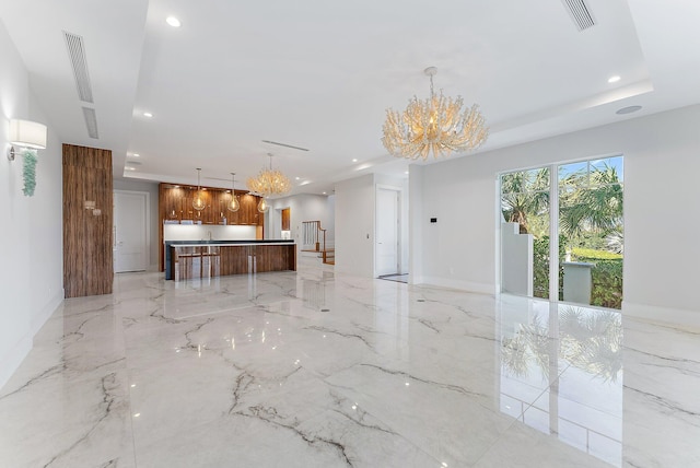 unfurnished living room featuring an inviting chandelier