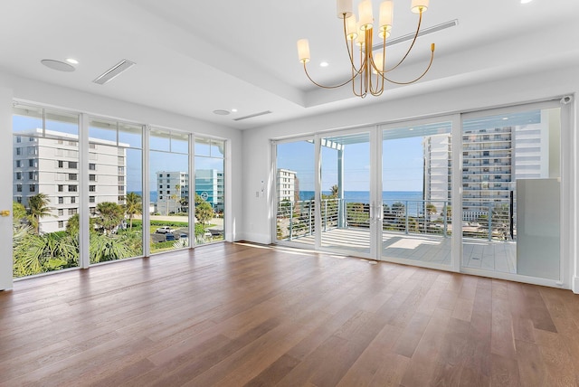 unfurnished room with a chandelier and wood-type flooring