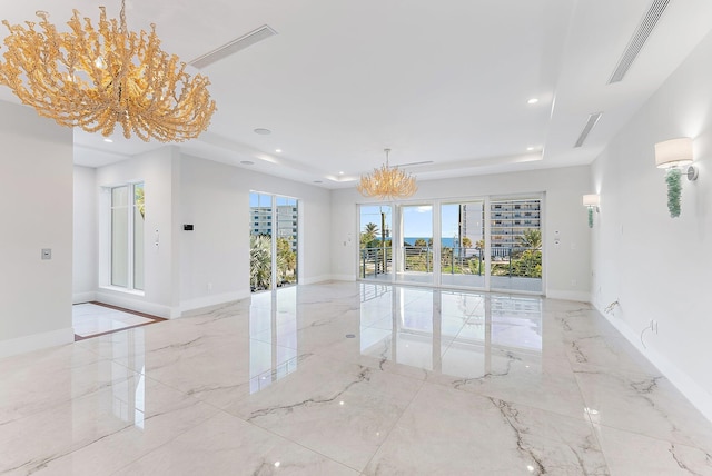 spare room featuring a chandelier