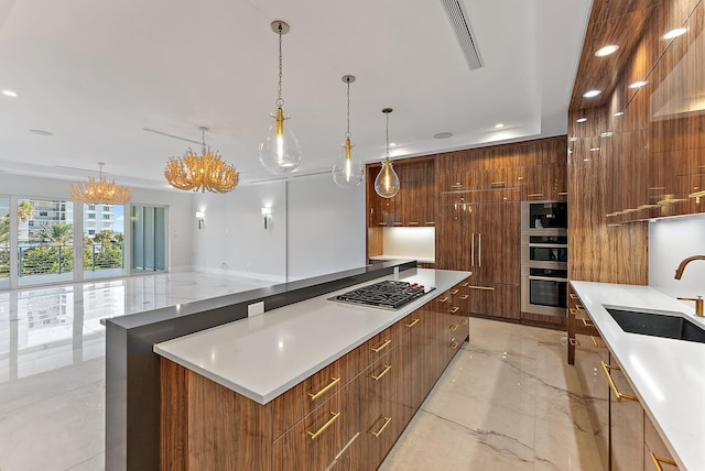 kitchen featuring hanging light fixtures, a spacious island, a notable chandelier, and appliances with stainless steel finishes