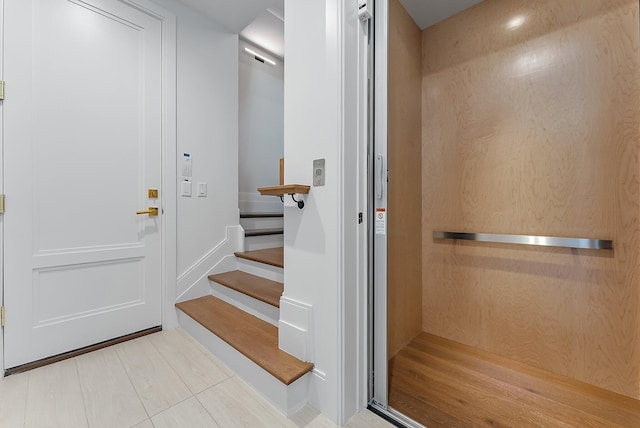 bathroom featuring elevator and tile patterned floors