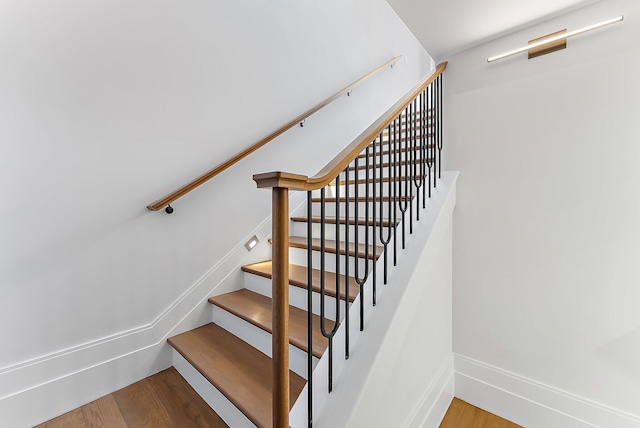 stairs featuring hardwood / wood-style floors