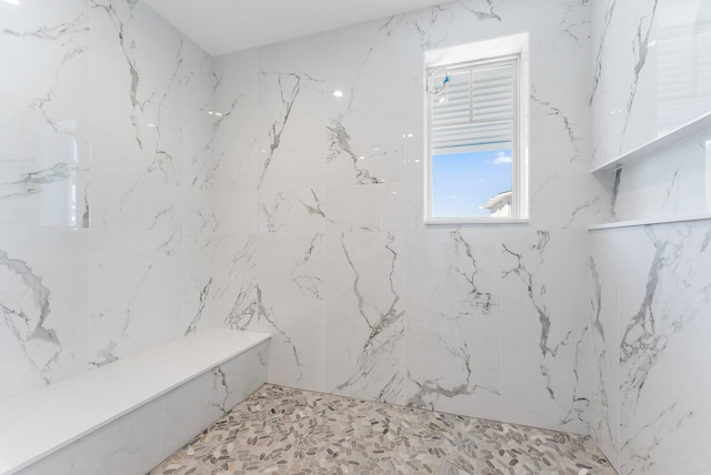 bathroom featuring a tile shower