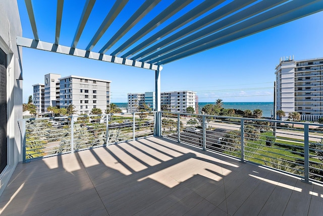 deck featuring a pergola and a water view