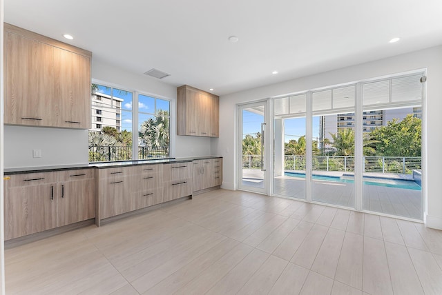 kitchen featuring light brown cabinets and plenty of natural light