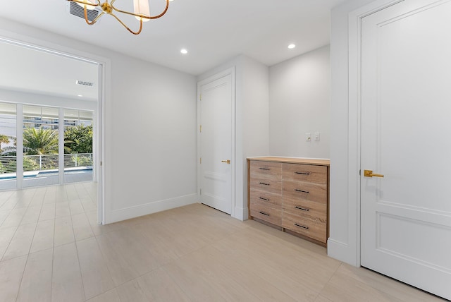 unfurnished room with a chandelier