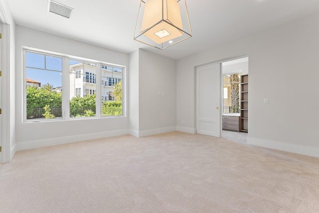 spare room with light colored carpet