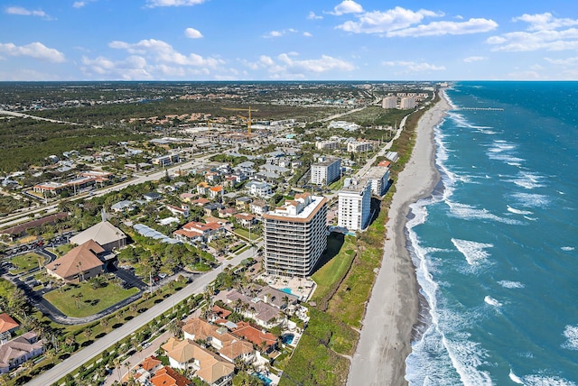 drone / aerial view featuring a water view and a beach view