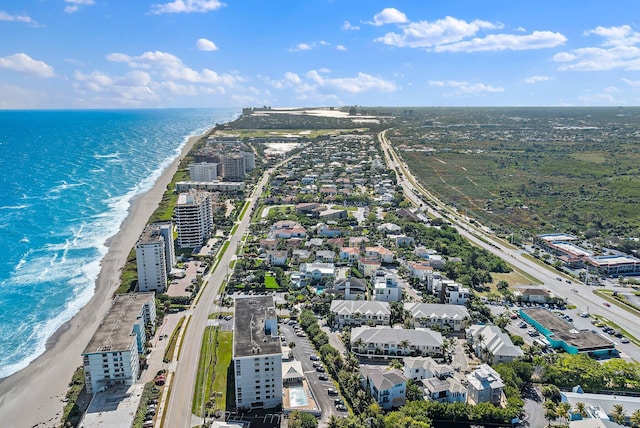 birds eye view of property featuring a water view and a view of the beach