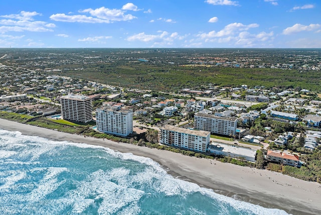 drone / aerial view with a beach view and a water view