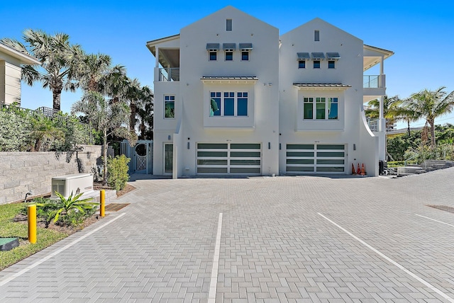 view of front of home featuring a balcony and a garage