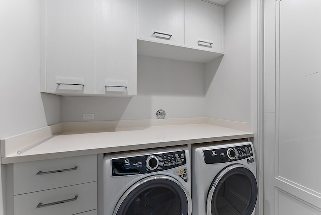 laundry room featuring cabinets and separate washer and dryer