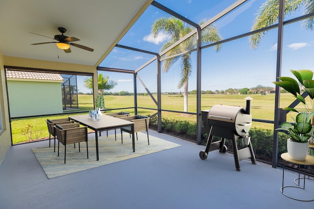 sunroom featuring ceiling fan