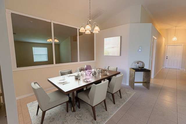 dining space with lofted ceiling, a notable chandelier, and light tile patterned flooring