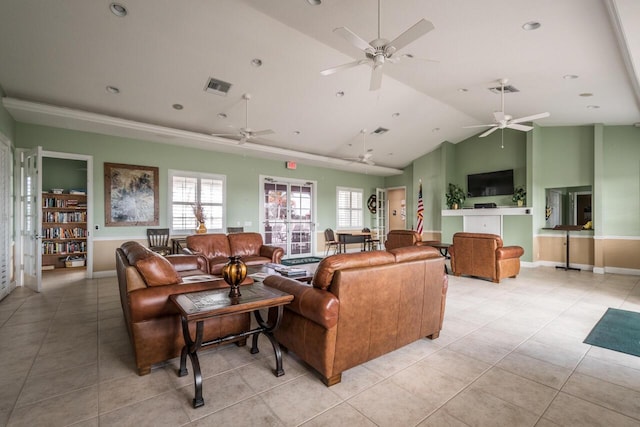 living room featuring ceiling fan, vaulted ceiling, and light tile patterned floors