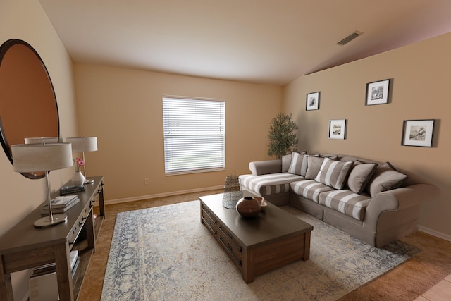 carpeted living room featuring vaulted ceiling