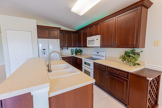 kitchen with white appliances, an island with sink, sink, and light tile patterned floors