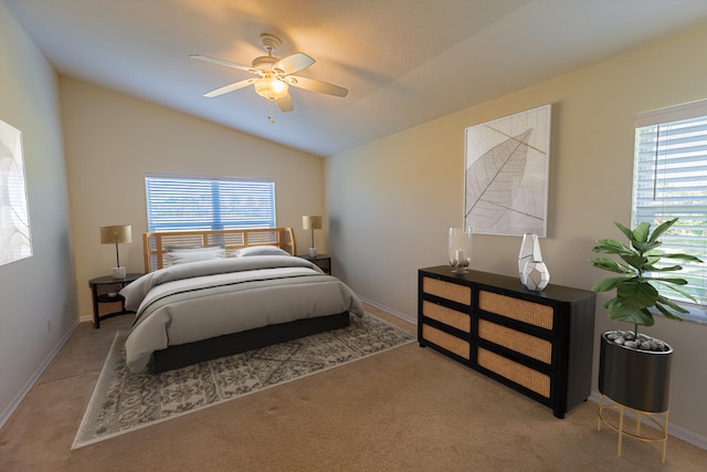 bedroom with ceiling fan, vaulted ceiling, and light carpet