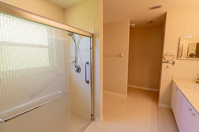 bathroom with vanity and a shower with shower door