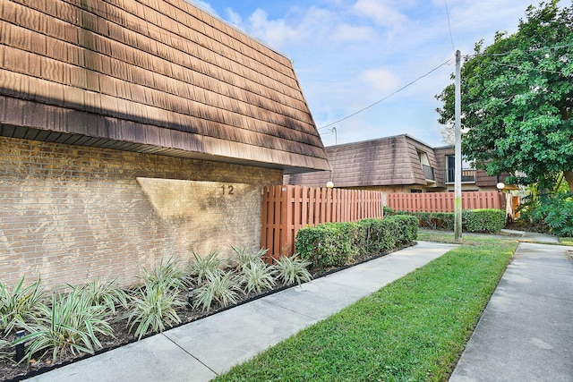 view of side of home featuring a lawn