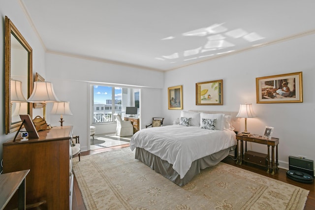 bedroom with wood-type flooring and crown molding