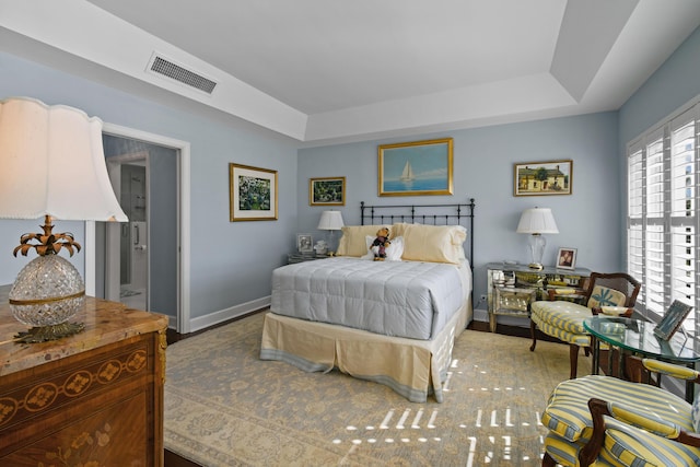 bedroom featuring a raised ceiling