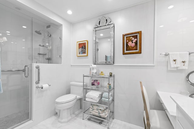 bathroom with vanity, toilet, tile walls, and a shower with shower door