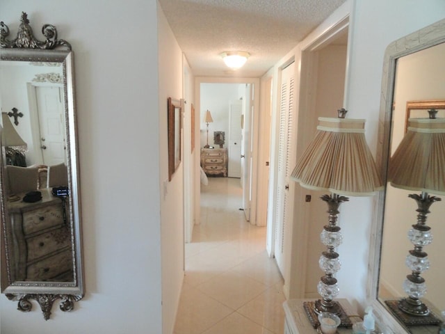 810 Sky Pine Way Unit F2, Greenacres, FL 33415 - corridor with a textured ceiling and light tile patterned floors