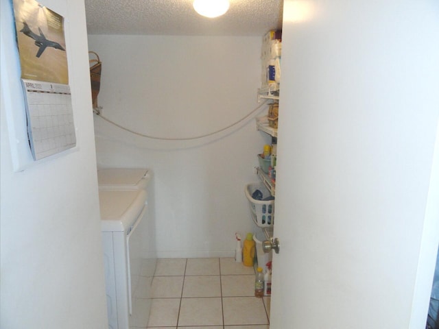 810 Sky Pine Way Unit F2, Greenacres, FL 33415 - laundry area with washer and clothes dryer, light tile patterned floors, and a textured ceiling