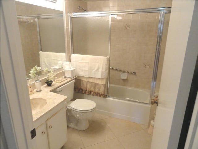 full bathroom with toilet, vanity, tile patterned floors, and combined bath / shower with glass door