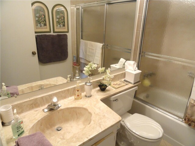 810 Sky Pine Way Unit F2, Greenacres, FL 33415 - bathroom with vanity, shower / bath combination with glass door, and toilet