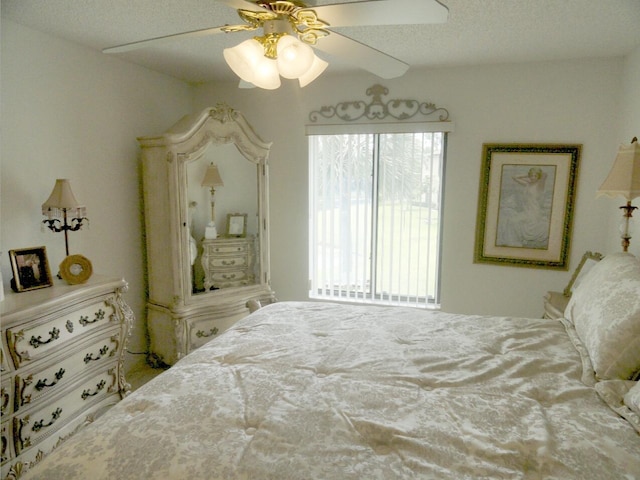 bedroom featuring ceiling fan, lofted ceiling, and a textured ceiling