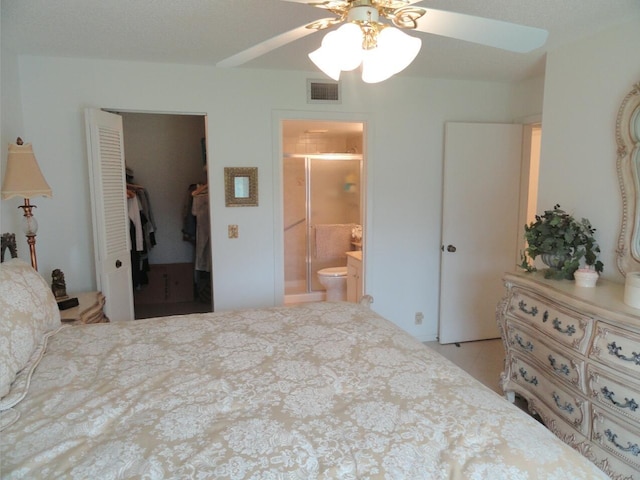 bedroom with ensuite bathroom, a closet, ceiling fan, and light tile patterned flooring