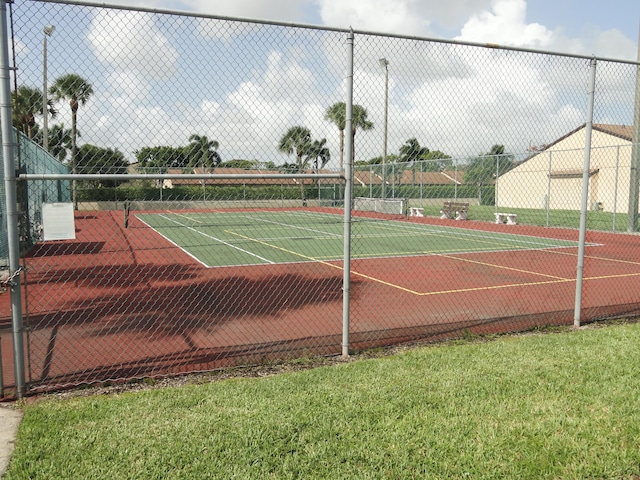 view of sport court featuring a yard