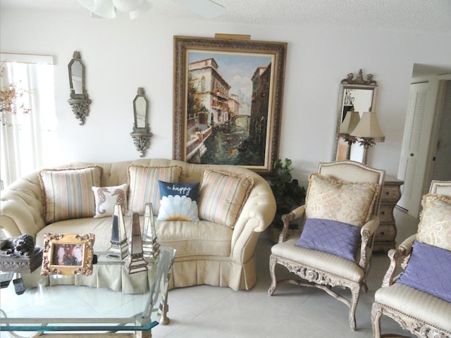 living room with light tile patterned flooring and a textured ceiling