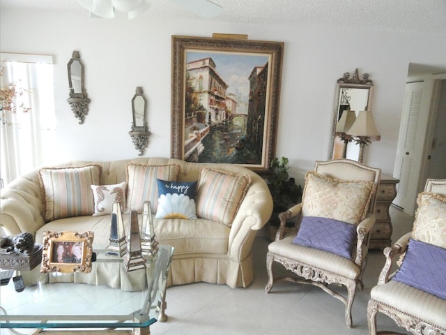 810 Sky Pine Way Unit F2, Greenacres, FL 33415 - tiled living room featuring a textured ceiling and a ceiling fan